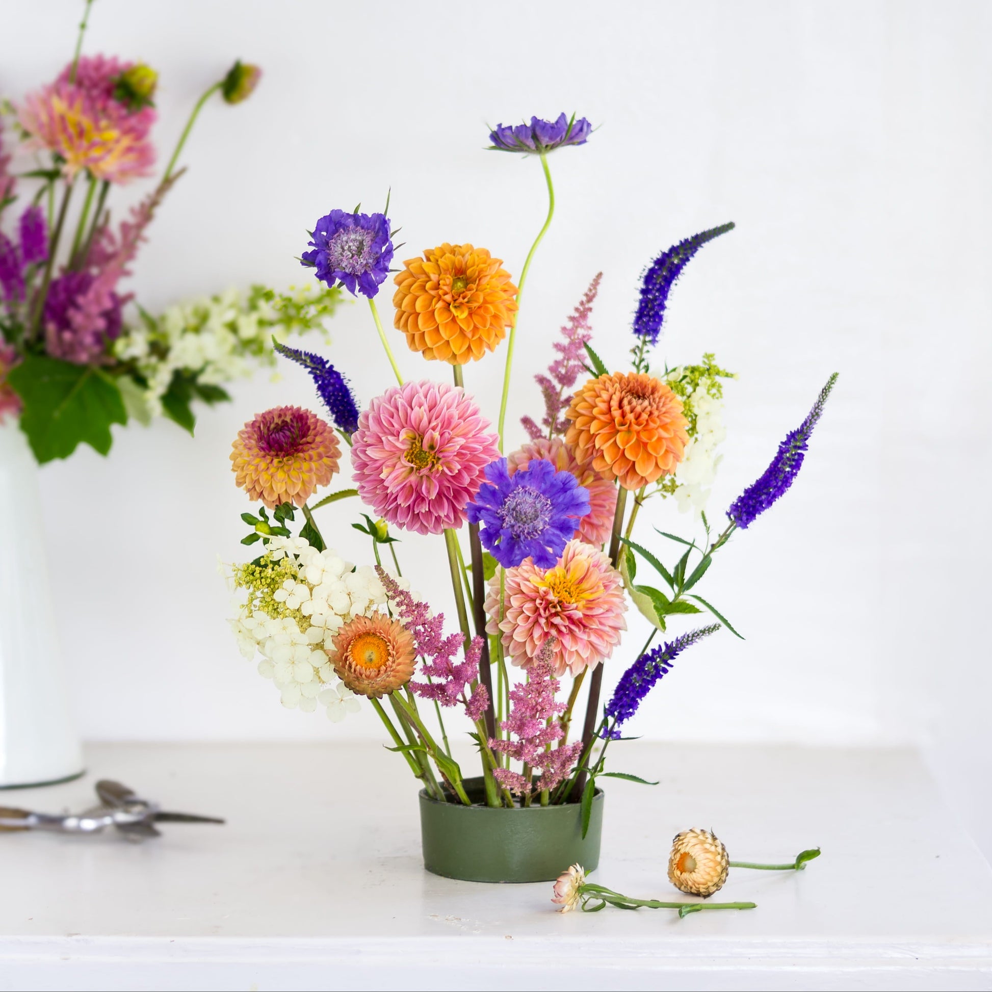 Large round pin cup flower frog kenzan with brightly colored flowers