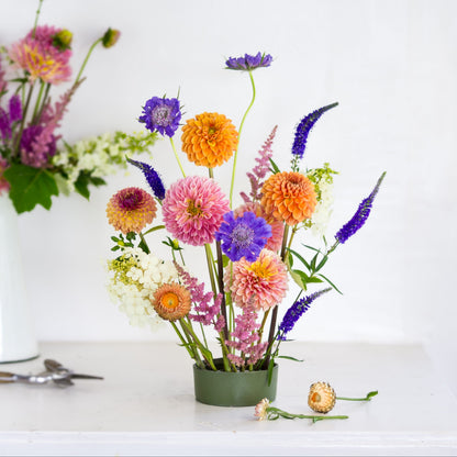 Large round pin cup flower frog kenzan with brightly colored flowers